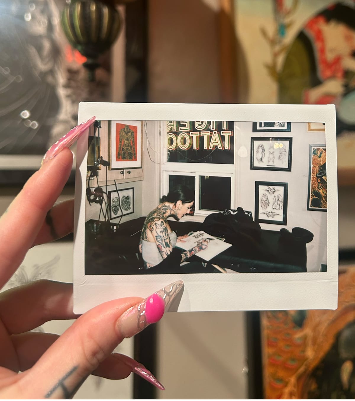 A polaroid of Natasha tattooing in the studio