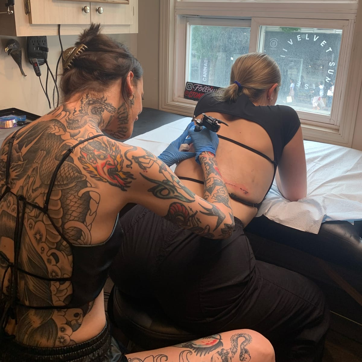 Natasha Smith tattooing a client’s back